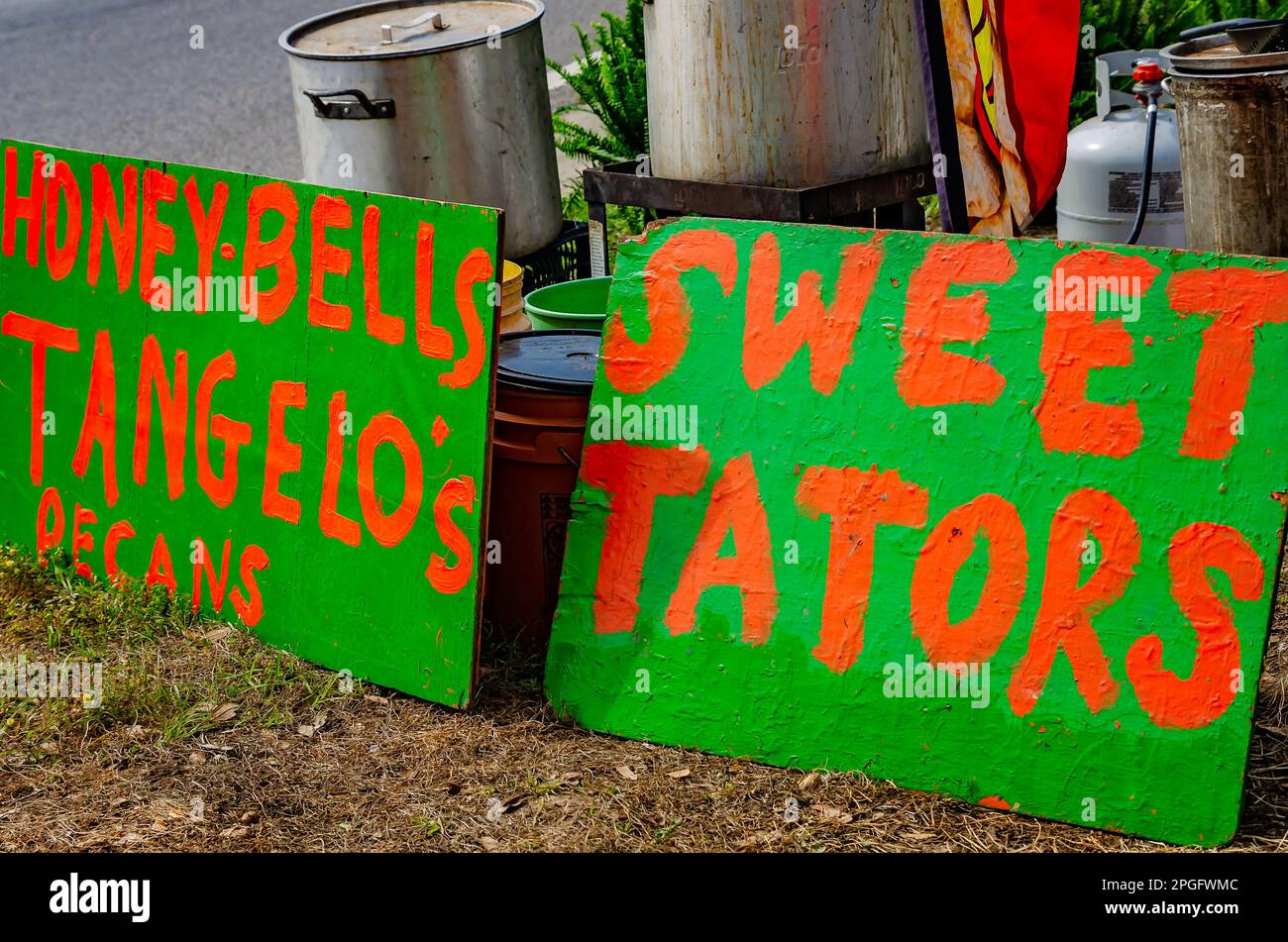 Signs for assorted fruits and vegetables are displayed at a roadside stand on Mississippi Highway 63, March 20, 2023, in Moss Point, Mississippi. Stock Photo