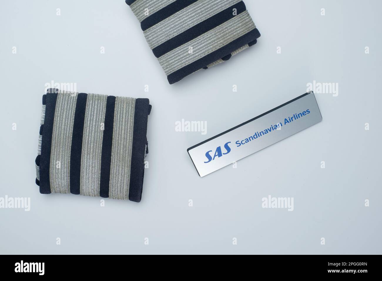 Helsinki / Finland - MARCH 23, 2023, Flatlay closeup of first officer epaulets and an aviator badge. Scandinavian Airlines System SAS Stock Photo