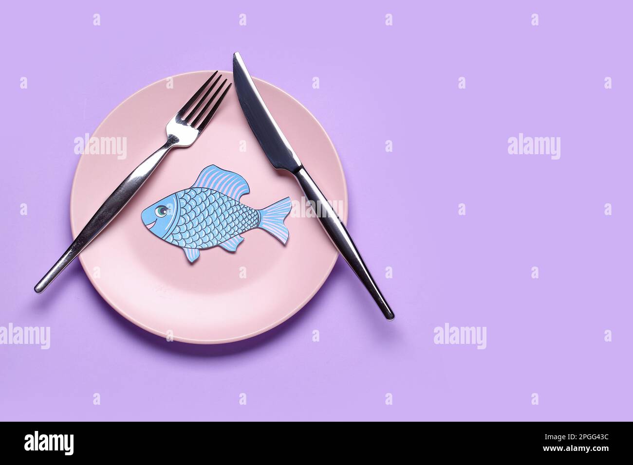 Table setting with paper fish on lilac background. April Fools' Day ...