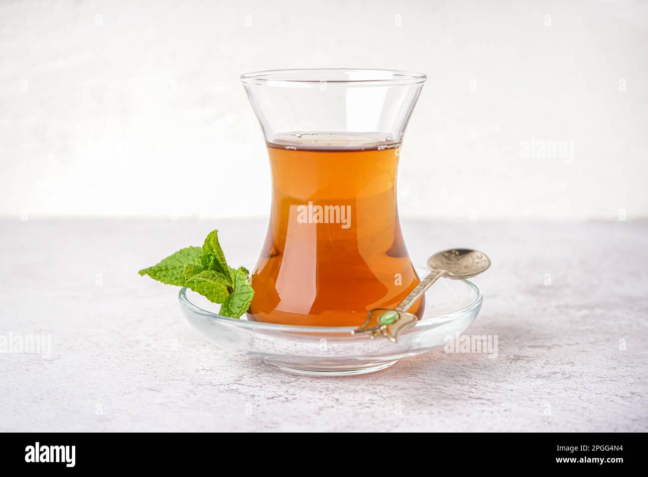Glass of Turkish tea on white background Stock Photo - Alamy