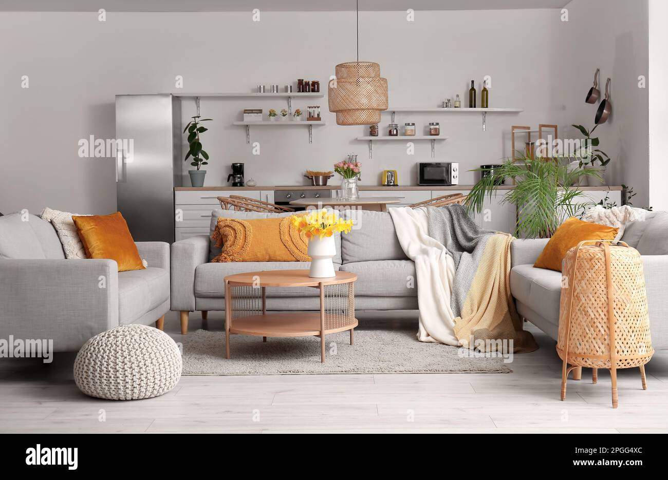 Interior of modern living room with cozy sofas and flower vase on ...