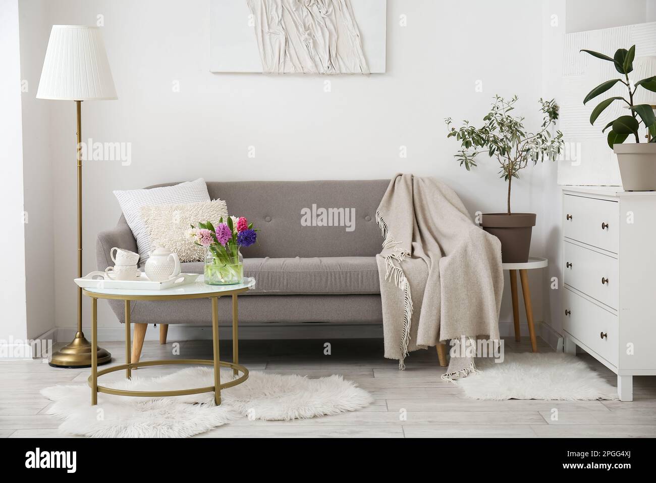 Interior of modern living room with cozy sofa, coffee table and lamp ...