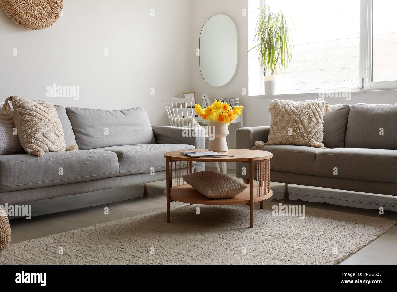 Interior of modern living room with cozy sofas and flower vase on ...