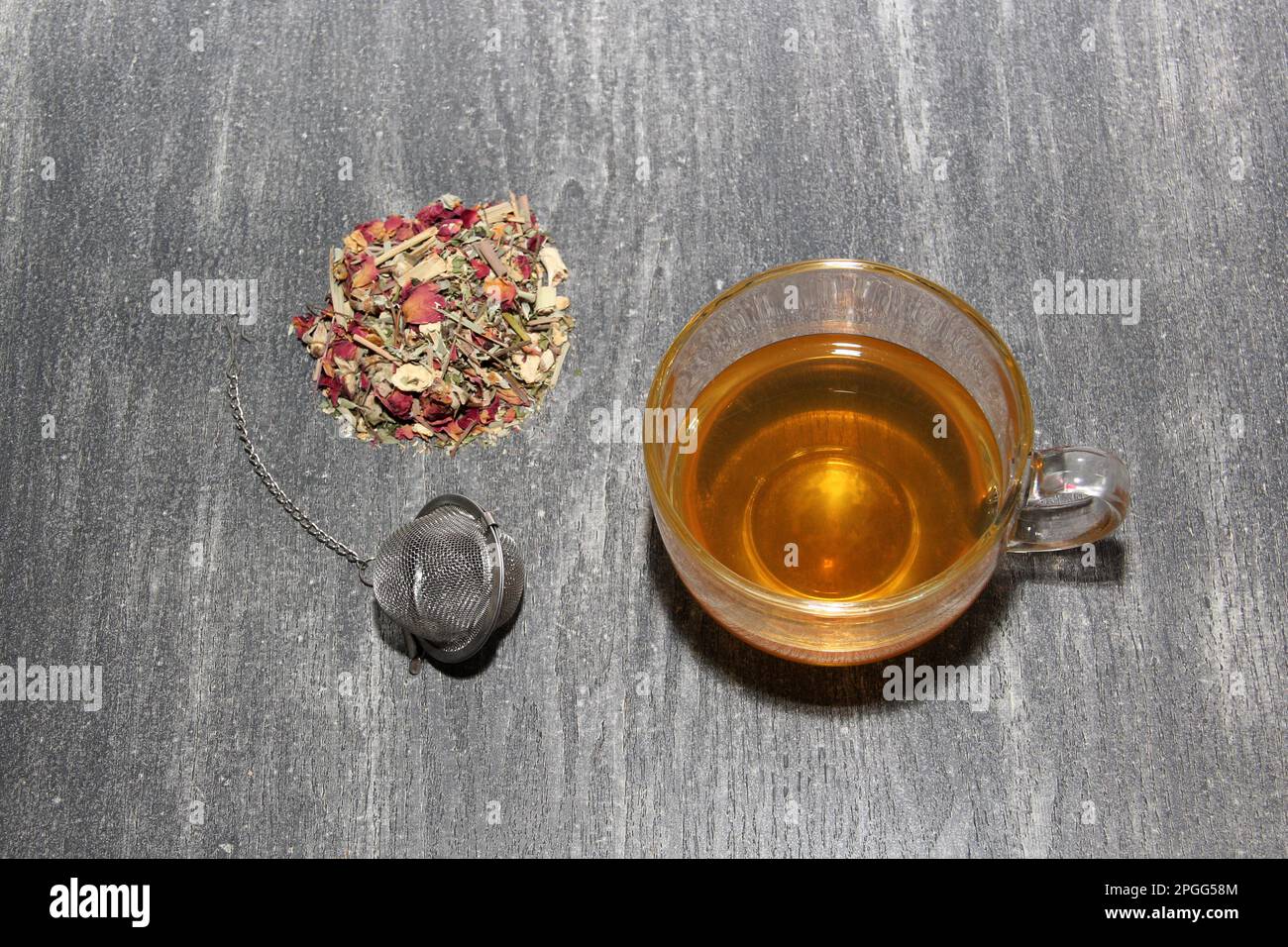 Tools for the preparation of herbal tea: glass cup, infuser, spoon ...