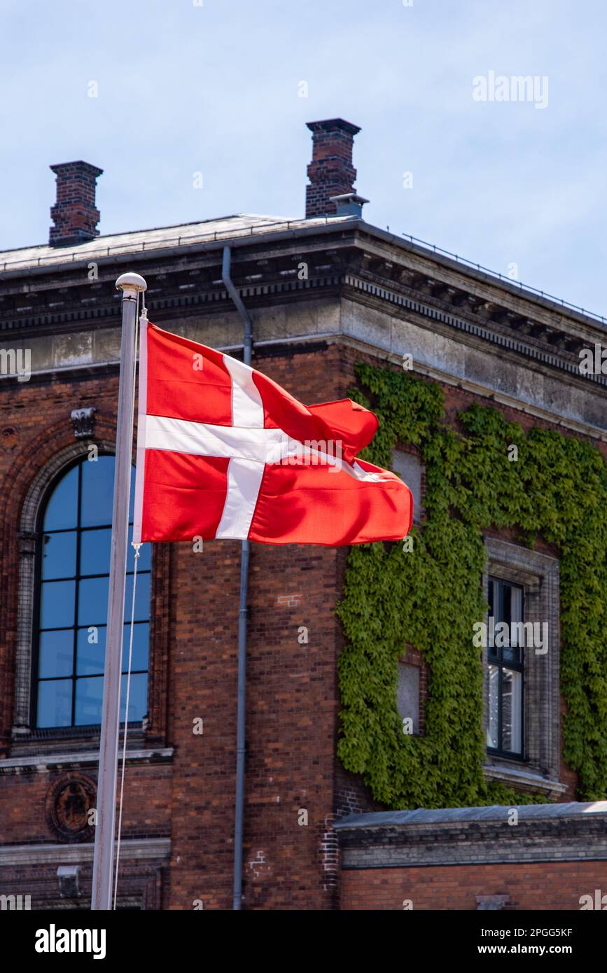 Danish flag in front of a brick building Stock Photo