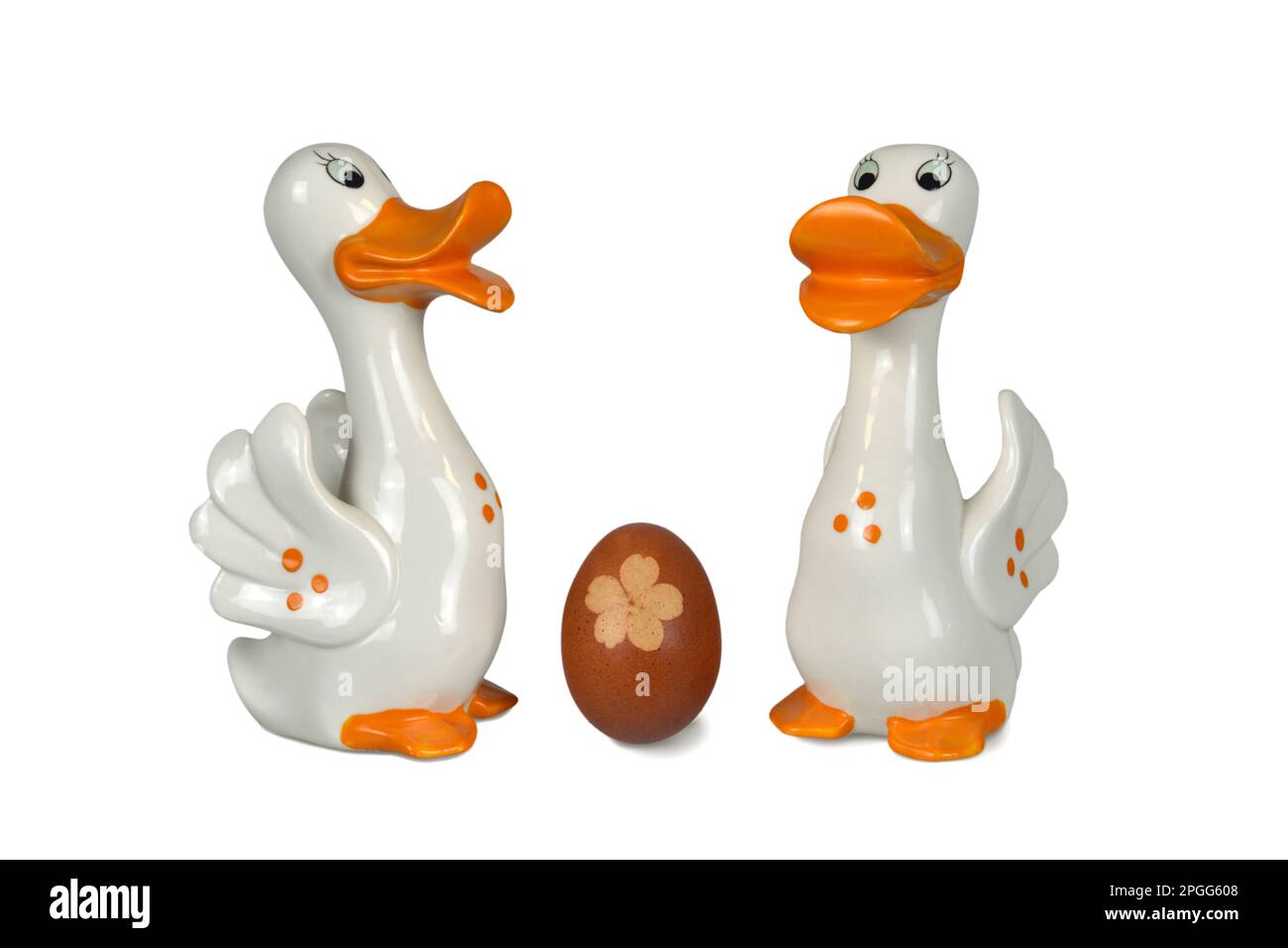Easter decoration isolated on white background. Duck figurines and natural dyed Easter egg. Stock Photo