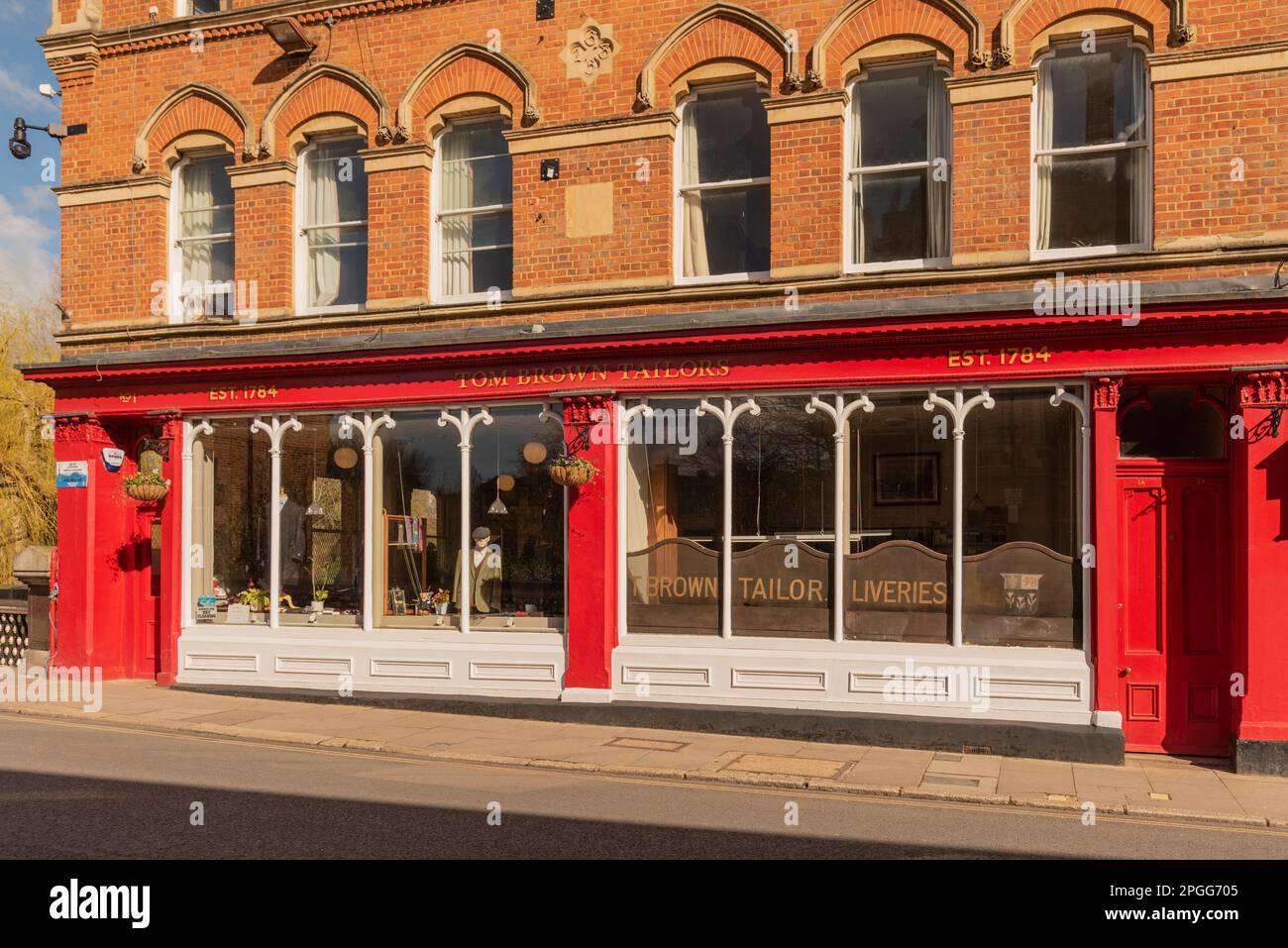 Eton, Buckinghamshire, England, UK. 2023. Famous tailor shop painted red and white on High Street Eton Stock Photo