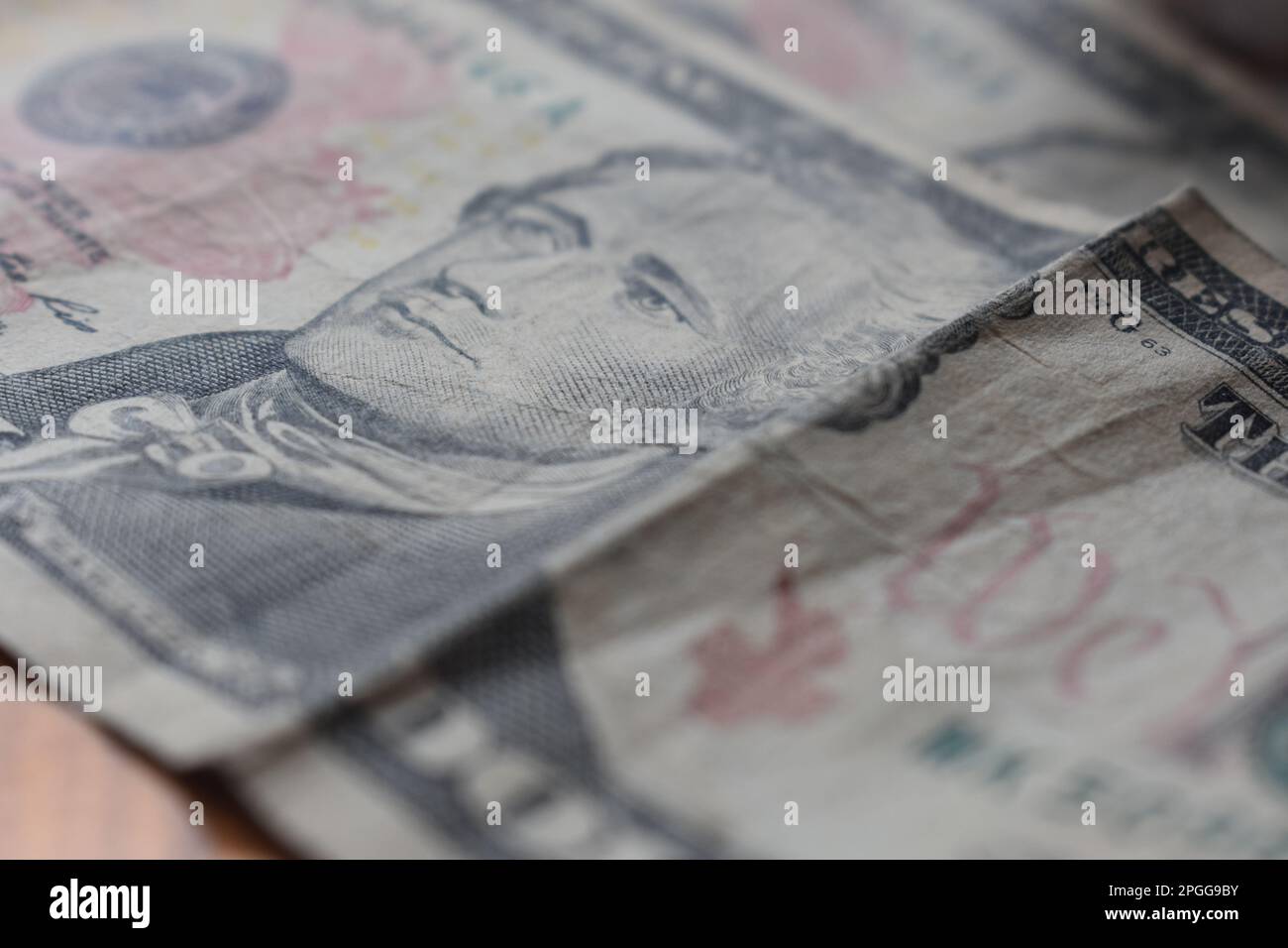 American 10 (ten) dollar bills lying on a table. Portrait of Alexander Hamilton.  United States, US, USA Stock Photo
