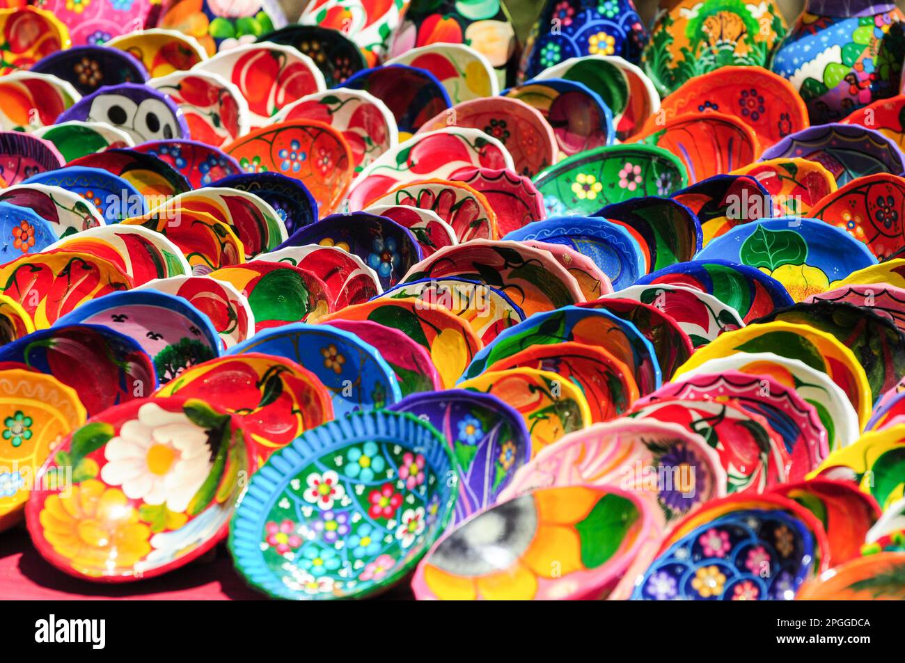 Multiple rows of multicolored hand painted saucers sold as souvenirs Stock Photo
