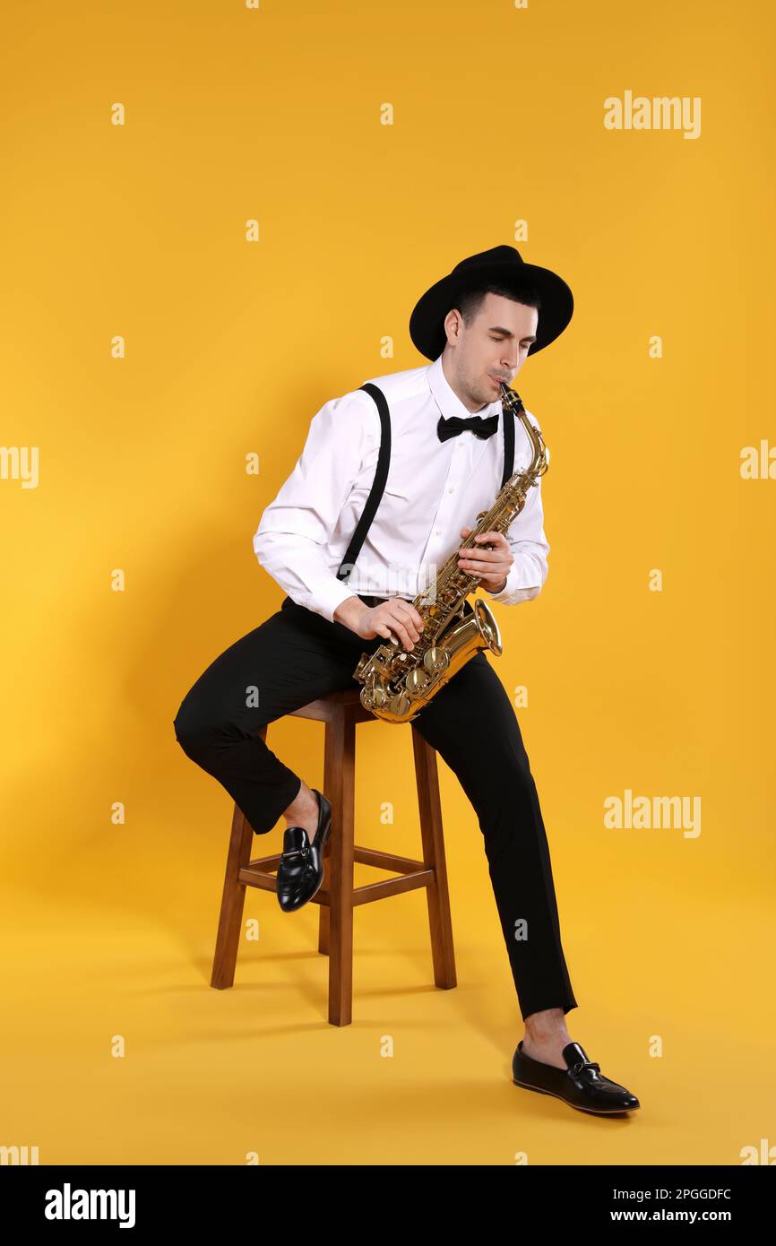 Young Man Plays Mini Saxophone with Bare Hands Stock Photo - Image
