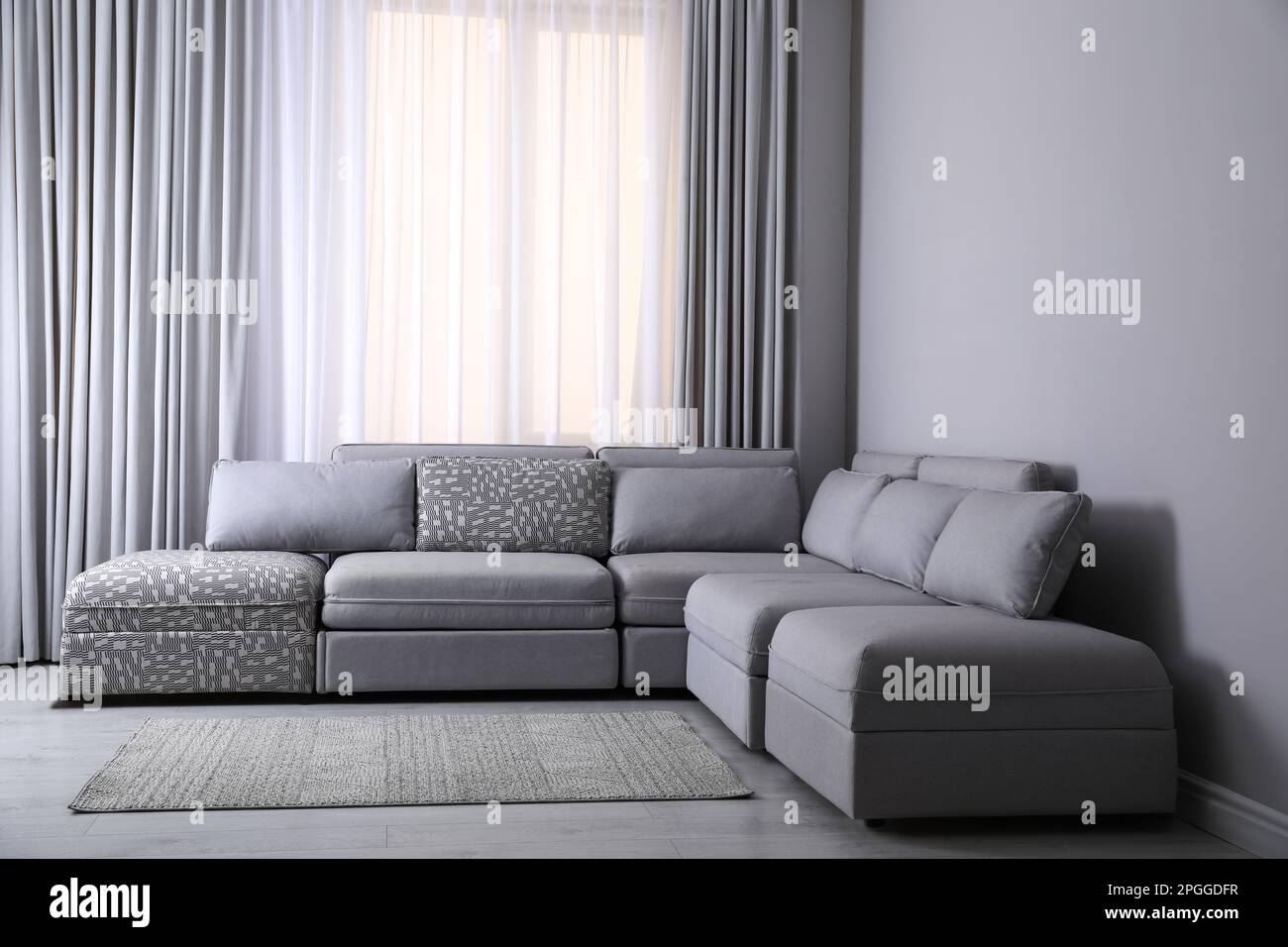 Large grey sofa in living room. Interior design Stock Photo - Alamy