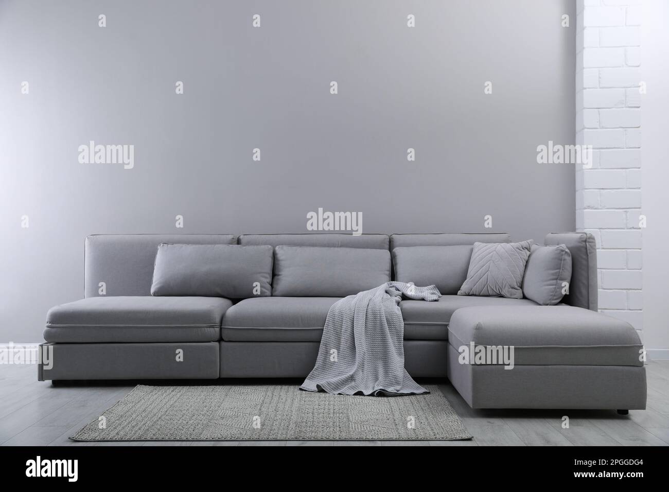 Large grey sofa in living room. Interior design Stock Photo - Alamy