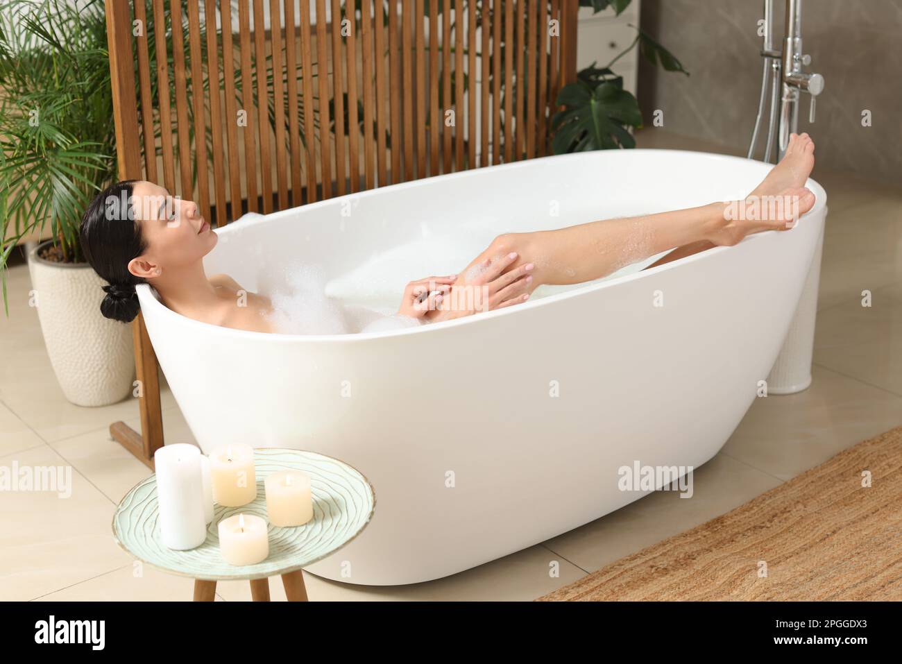 Beautiful young woman taking bubble bath at home Stock Photo Alamy