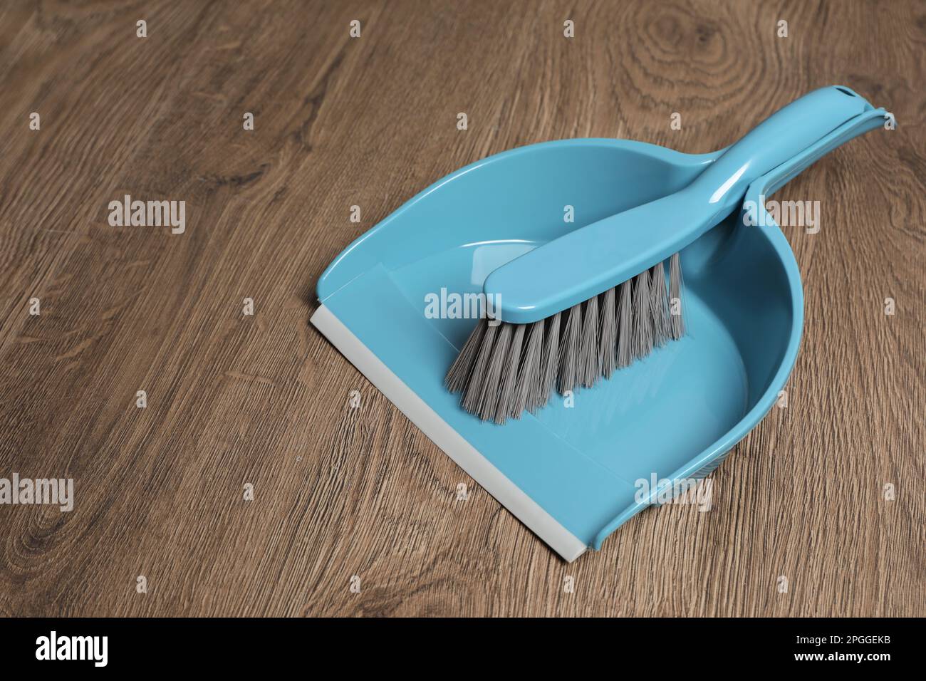 Plastic whisk broom with dustpan on wooden floor Stock Photo Alamy
