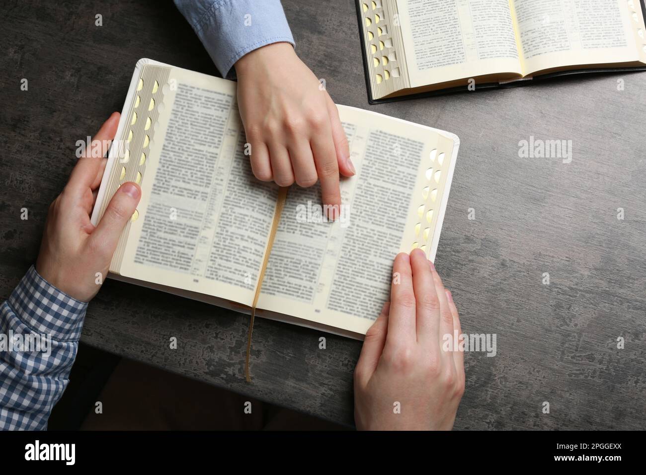 Humble couple reading Bibles at grey table together, top view Stock Photo Alamy