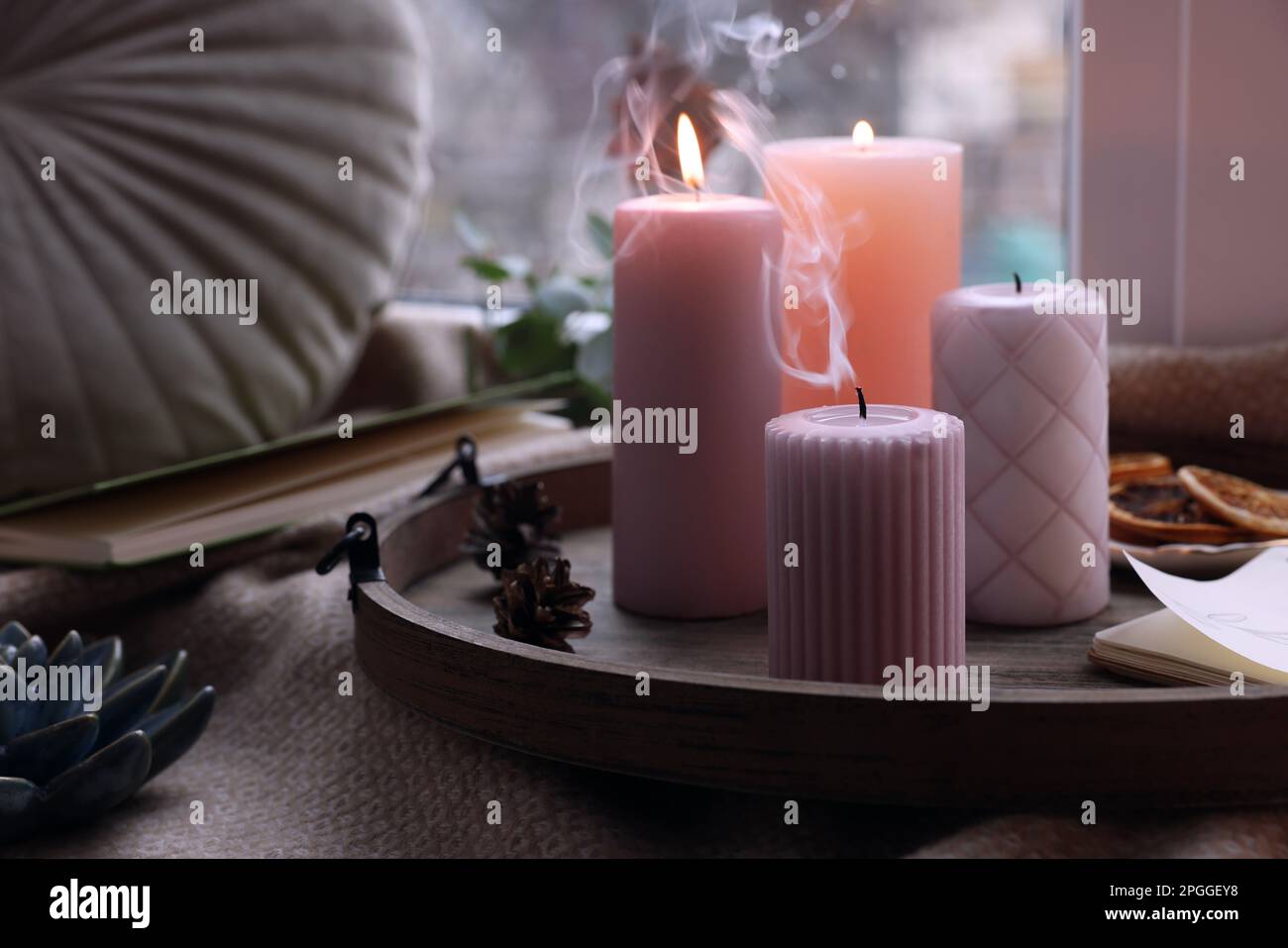 Tray with wax candles on window sill indoors Stock Photo Alamy