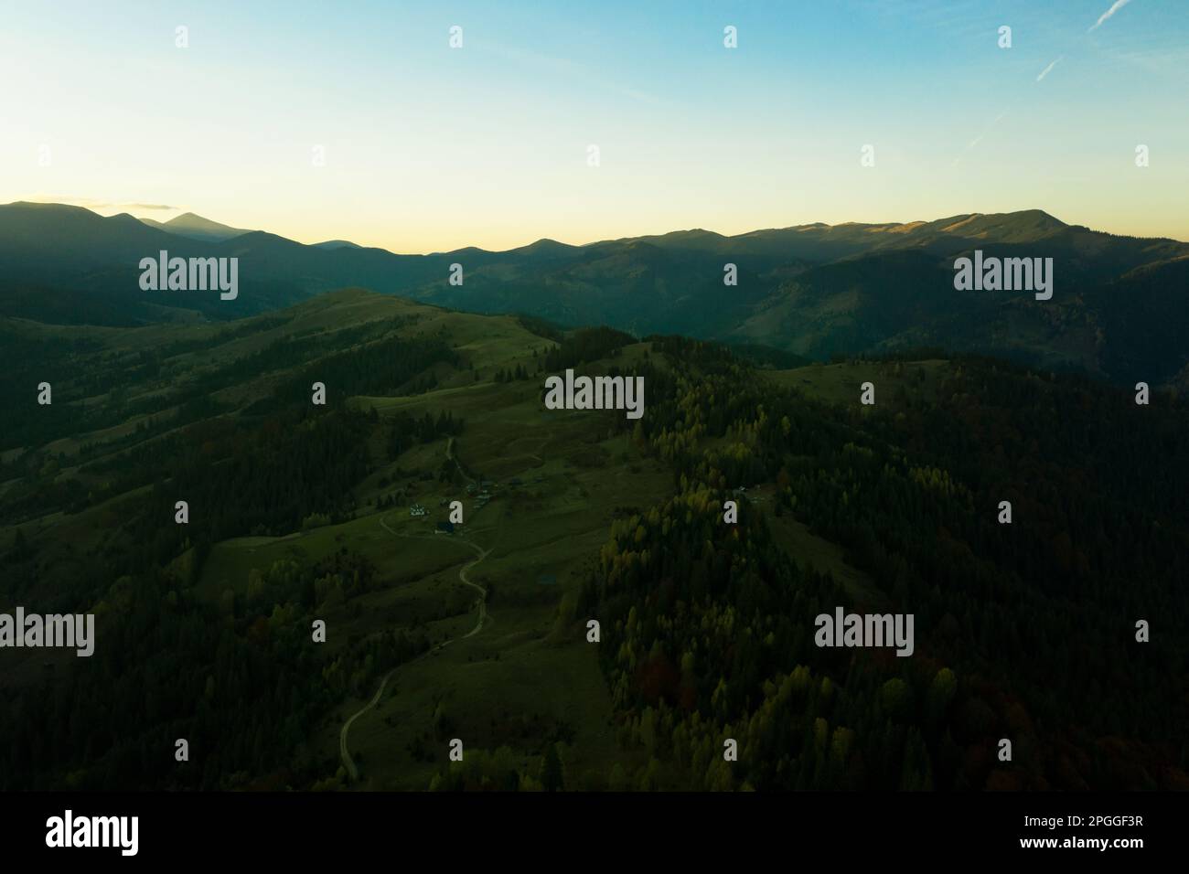 Aerial view of beautiful mountain landscape with village at sunrise ...