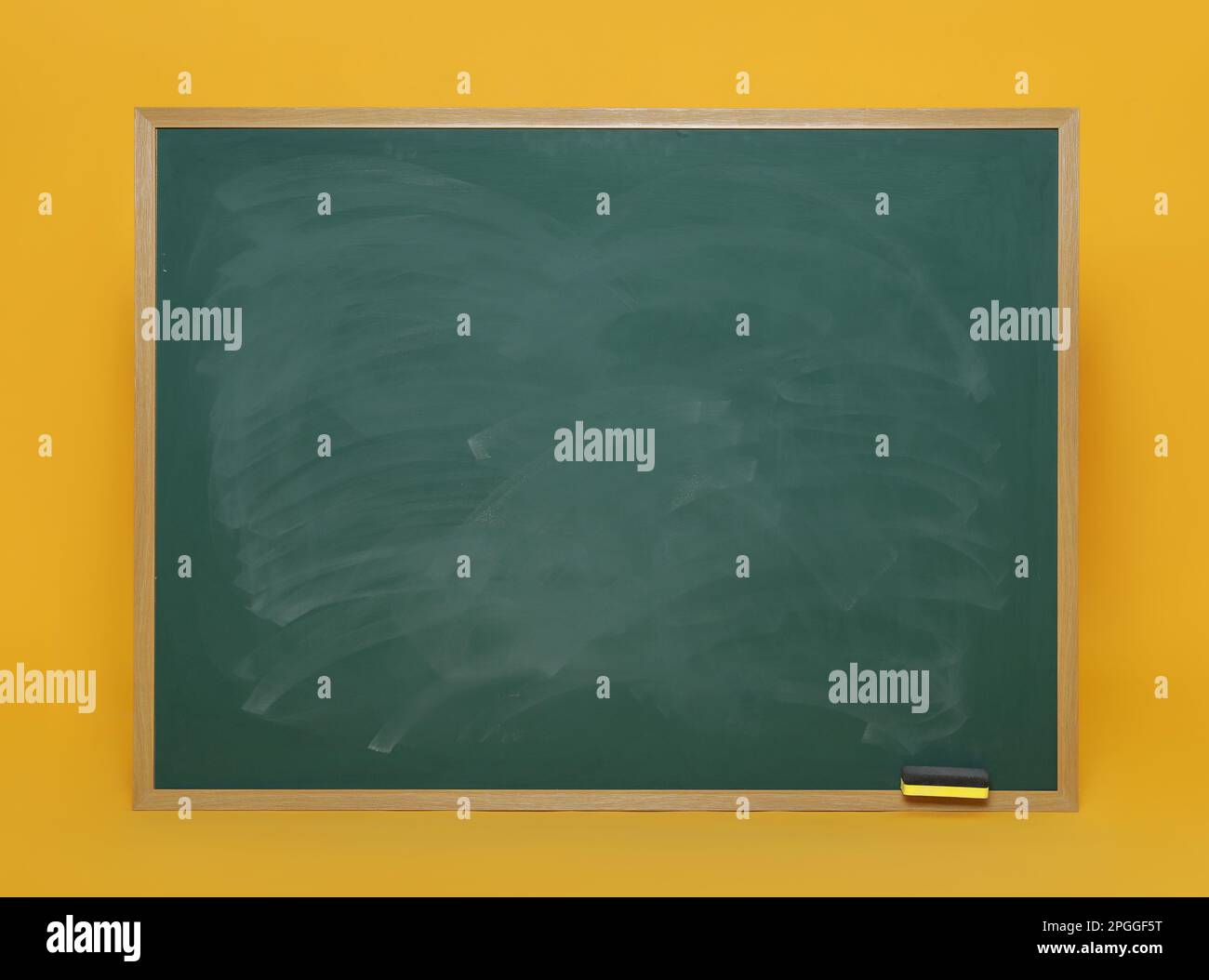 Dirty green chalkboard with duster on orange background Stock Photo Alamy