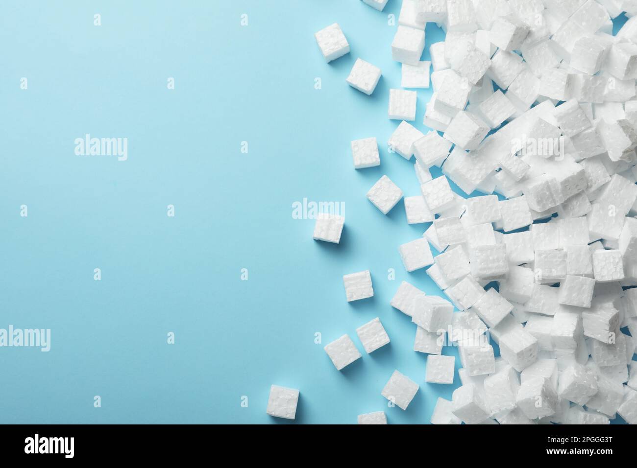 Many styrofoam cubes on light blue background, flat lay. Space for text Stock Photo