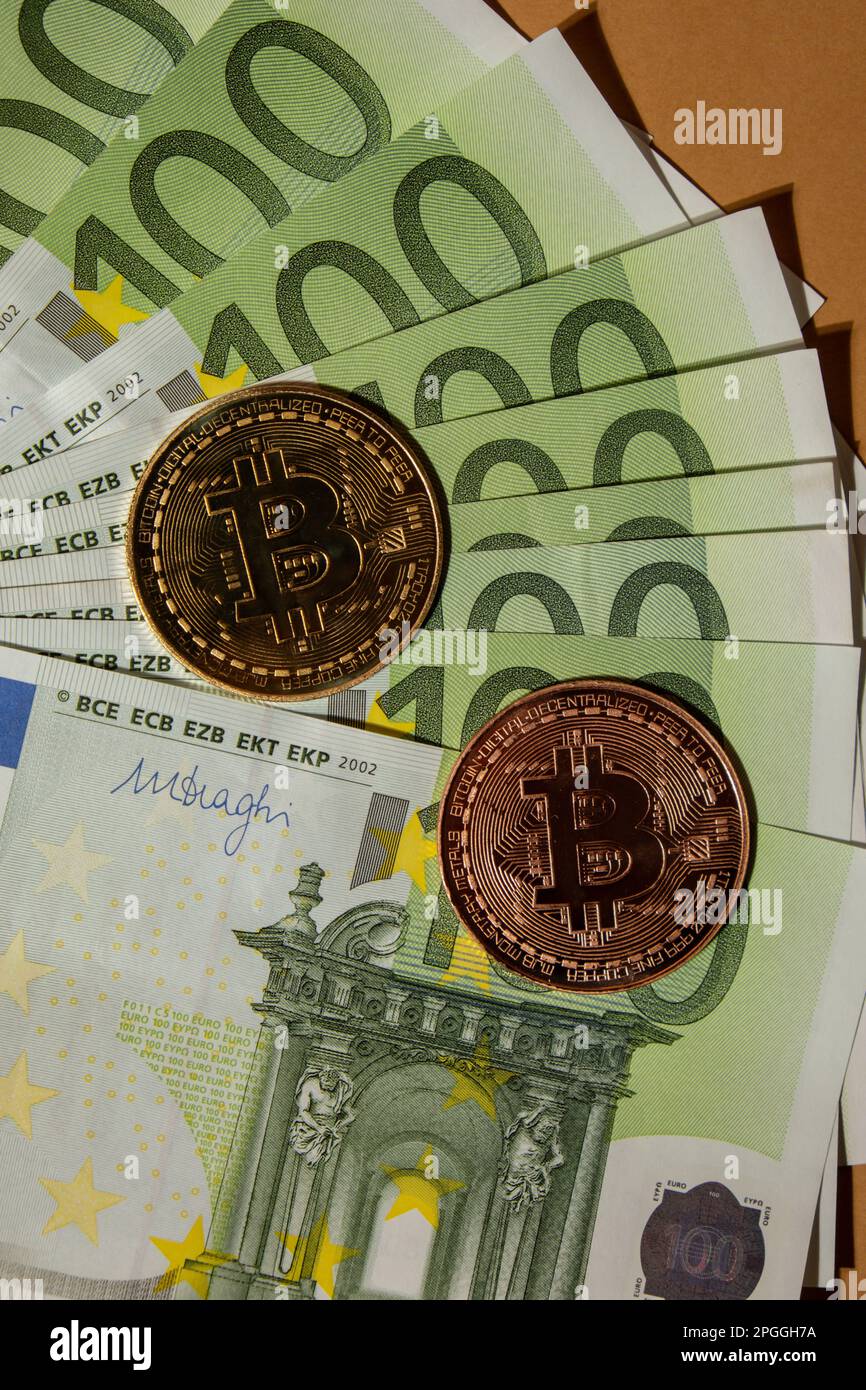 Bitcoin gold coin on bills of 100 euros eu currency. Bitcoin mining trading  concept. BTC golden money. Worldwide virtual internet Cryptocurrency or  crypto digital payment system. Digital coin money farm in digital
