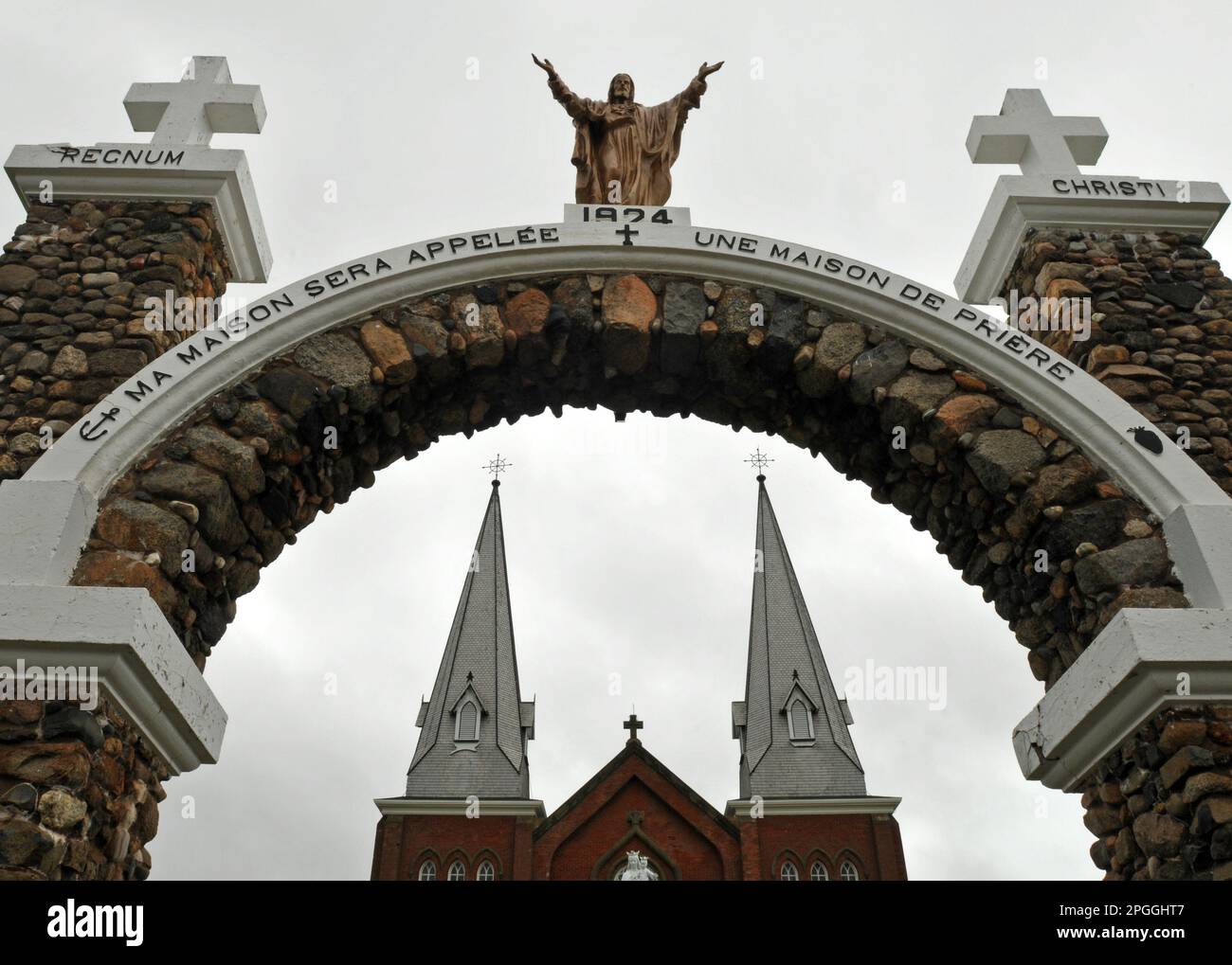 The bell towers of Notre Dame du Mont Carmel church at Mont Carmel, PEI are framed by a stone