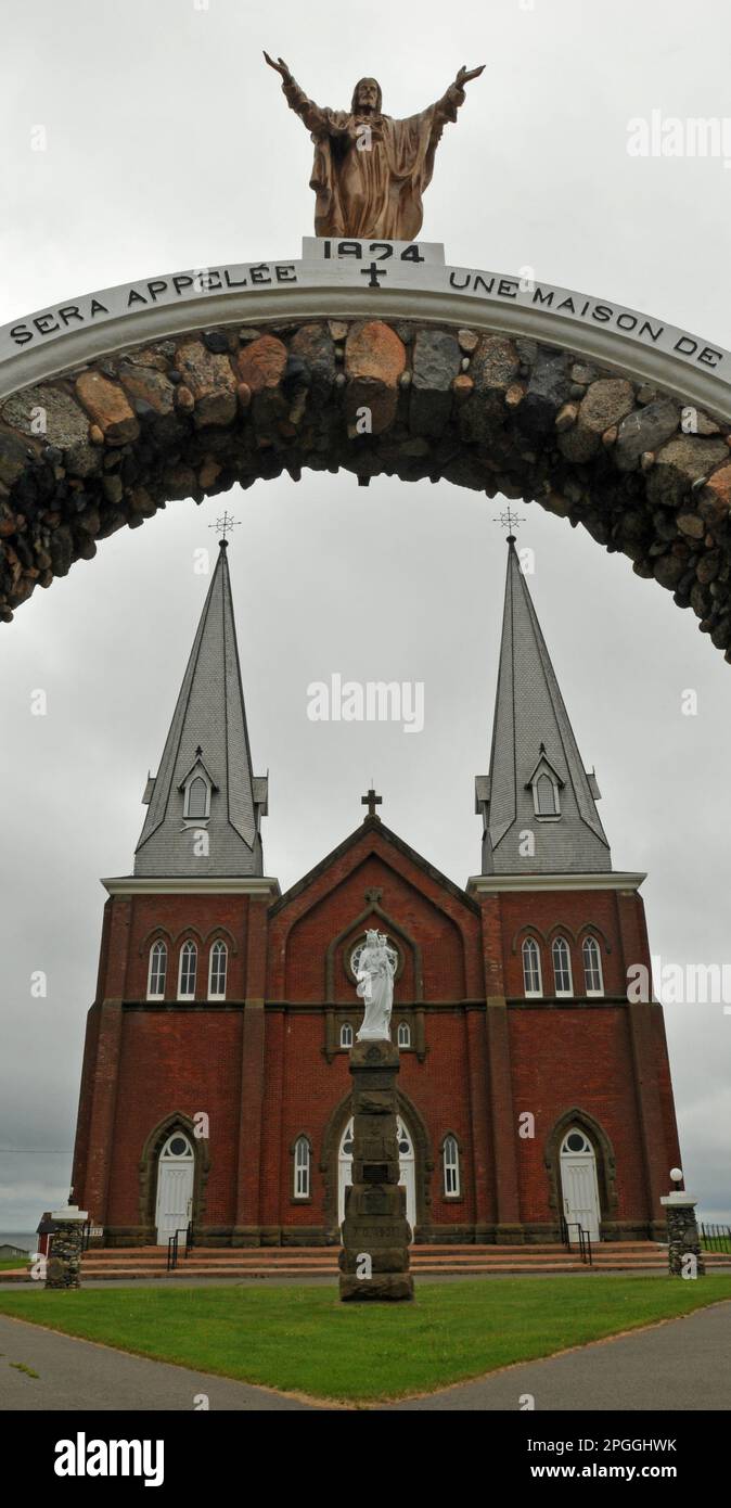 The imposing Notre Dame du Mont Carmel church at Mont Carmel, PEI is framed by a stone archway