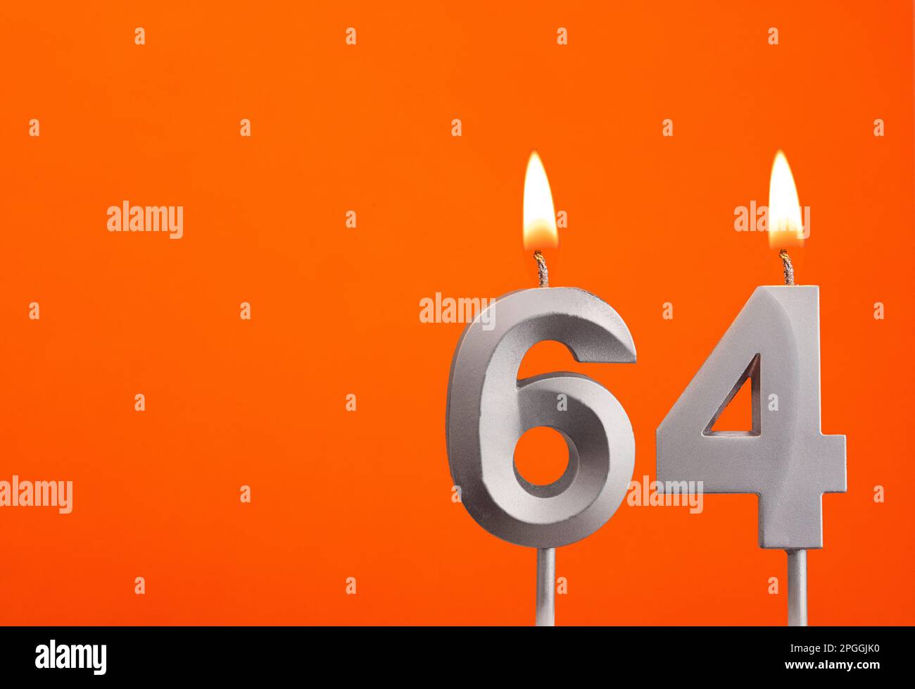 Candle number 64 - Birthday in orange background Stock Photo