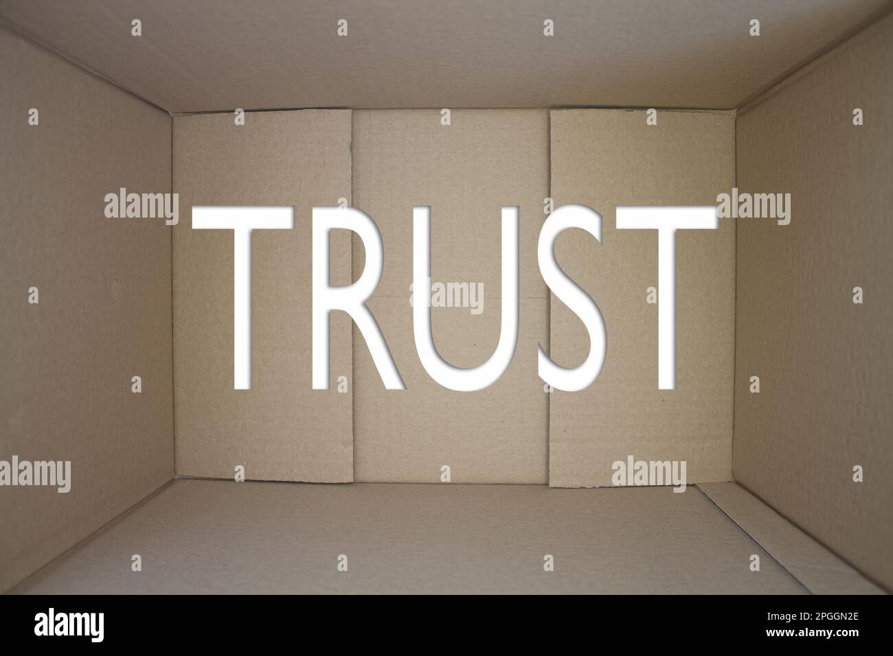 Trust word with cardboard box. Brown folded card box. Stock Photo