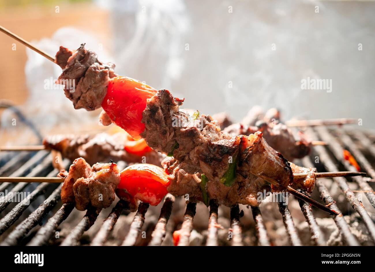 Grilled meat skewers. Close up of homemade roast beef on the grill, Roast beef skewer with