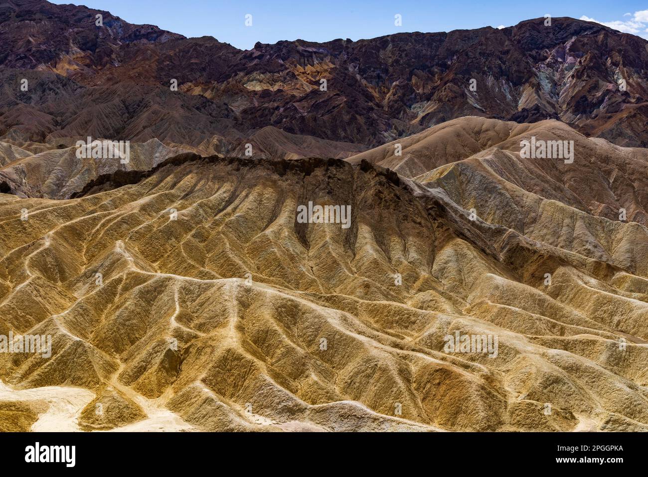 This is a view of the multi-colored 'badlands' looking south from  Zabriskie Point overlook in Death Valley National Park, California, USA. Stock Photo