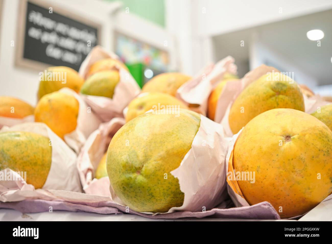 Ripe papayas for sale at a fruit and vegetable market stall. Stock Photo