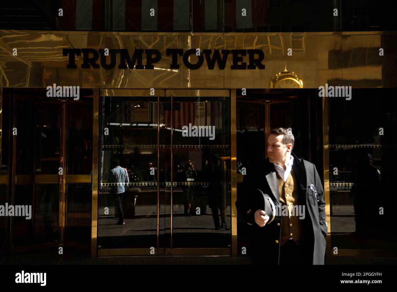 New York City, USA. 22nd Mar, 2023. A doorman stands in front of Trump Tower on Fifth avenue on