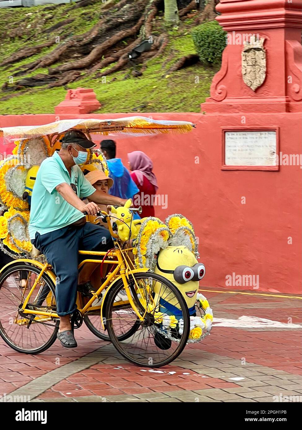 Malakka, Malaysia. 05th Mar, 2023. A rickshaw driver takes tourists on a tour of the city in his richly decorated Minions-themed vehicle. The world heritage site on the southwest coast of Malaysia is home to what are probably the world's most insane rickshaws. Tourists can explore the city's colonial history amid a frenzy of stuffed animals and plastic roses. (to dpa 'The world's craziest rickshaws: With Hello Kitty through Malacca ') Credit: Carola Frentzen/dpa/Alamy Live News Stock Photo