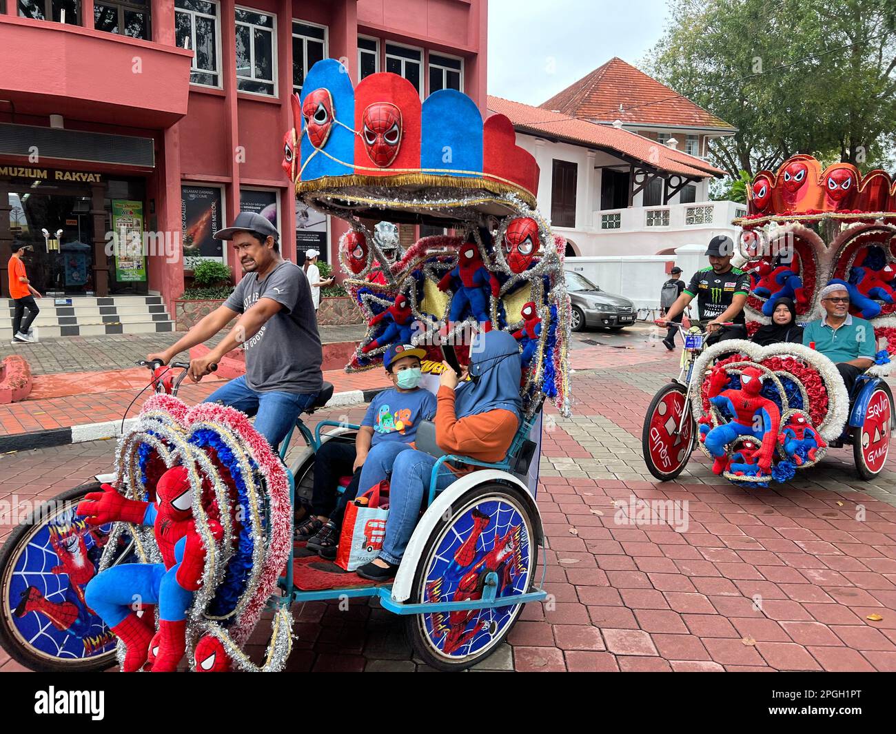 Malakka, Malaysia. 05th Mar, 2023. Rickshaw drivers take tourists on a city tour in their richly decorated Spiderman-themed vehicles. Arguably the most insane rickshaws on earth tour the World Heritage Site on Malaysia's southwest coast. Tourists can explore the city's colonial history amid a frenzy of stuffed animals and plastic roses. (to dpa 'The world's craziest rickshaws: With Hello Kitty through Malacca ') Credit: Carola Frentzen/dpa/Alamy Live News Stock Photo