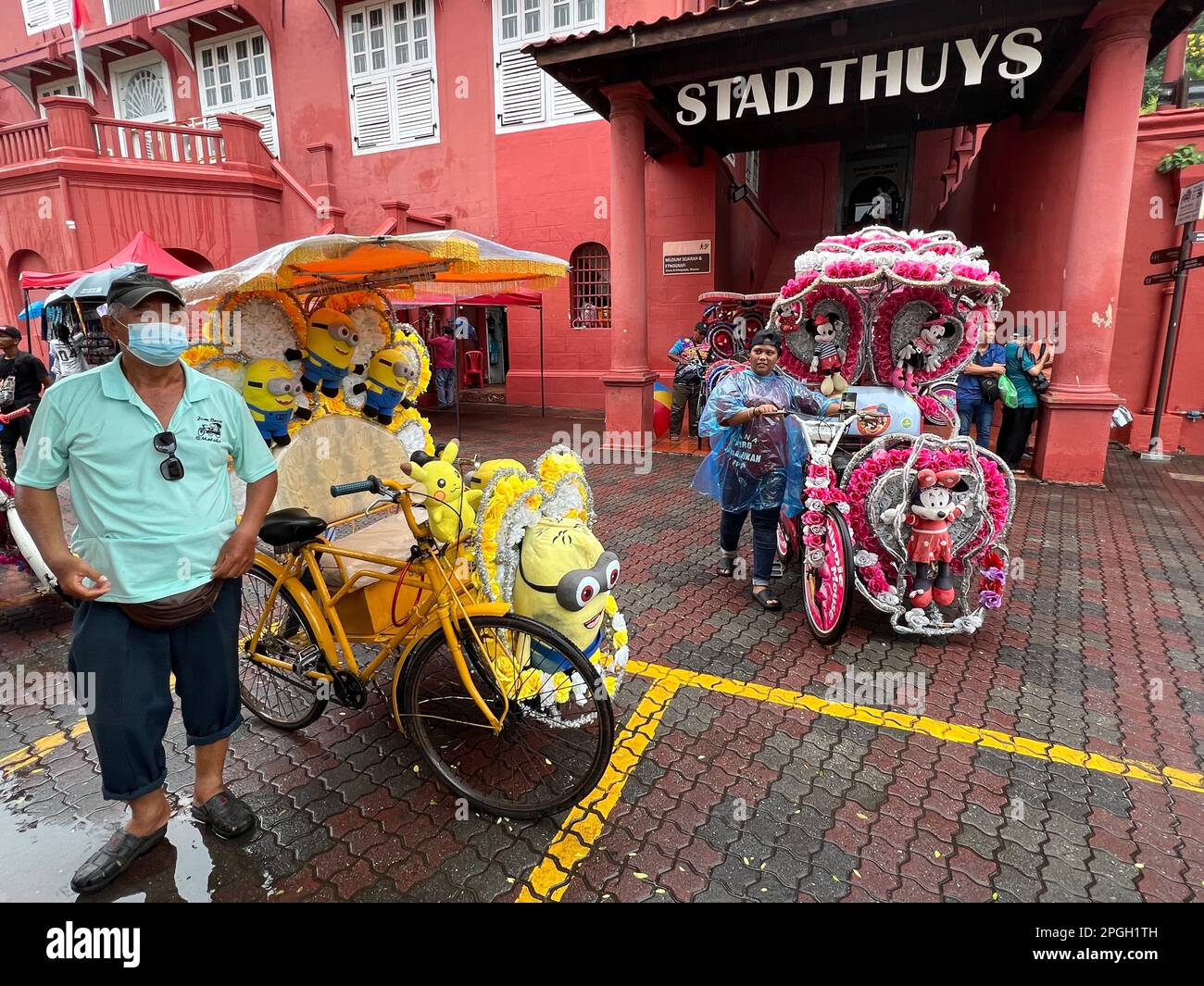 Malakka, Malaysia. 05th Mar, 2023. Rickshaw drivers wait for customers in front of the historic Stadthuys of Malacca. The world heritage site on the southwest coast of Malaysia is home to what are probably the world's craziest rickshaws. Tourists can explore the city's colonial history amid a frenzy of stuffed animals and plastic roses. (to dpa 'The world's craziest rickshaws: With Hello Kitty through Malacca ') Credit: Carola Frentzen/dpa/Alamy Live News Stock Photo