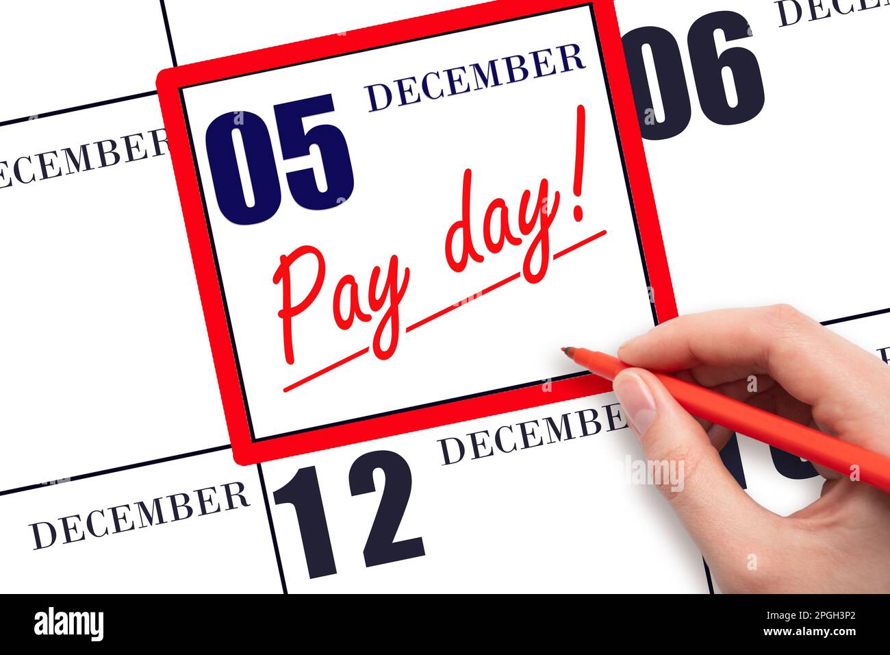 5th day of December. Hand writing text PAY DATE on calendar date December 5 and underline it. Payment due date. Reminder concept of payment. Winter mo Stock Photo