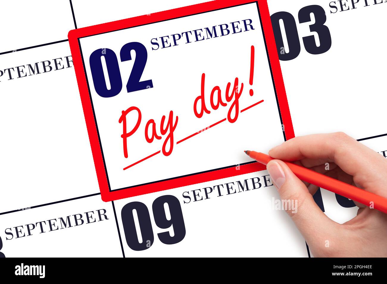 2nd day of September. Hand writing text PAY DATE on calendar date September 2 and underline it. Payment due date. Reminder concept of payment. Autumn Stock Photo