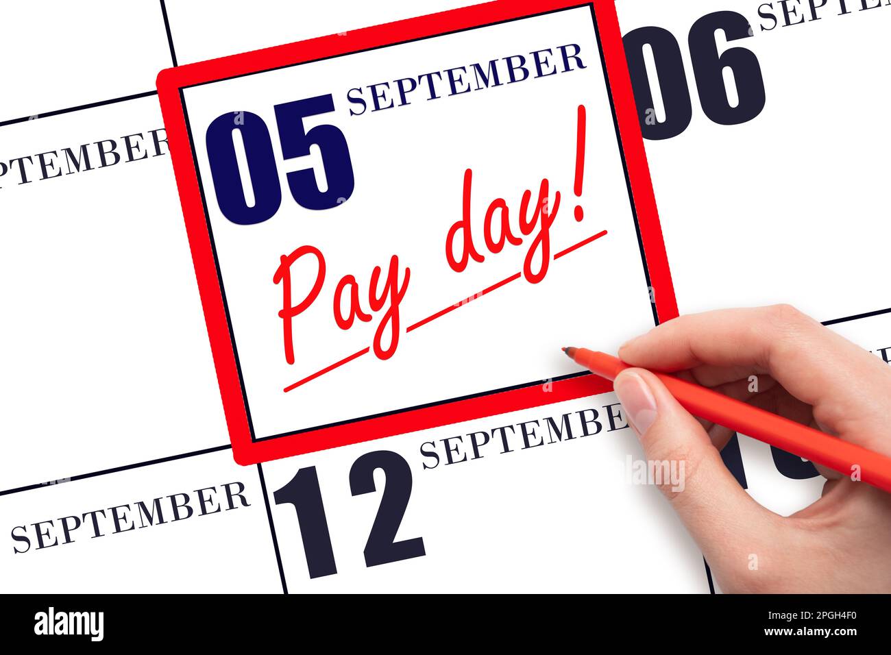 5th day of September. Hand writing text PAY DATE on calendar date September 5 and underline it. Payment due date. Reminder concept of payment. Autumn Stock Photo