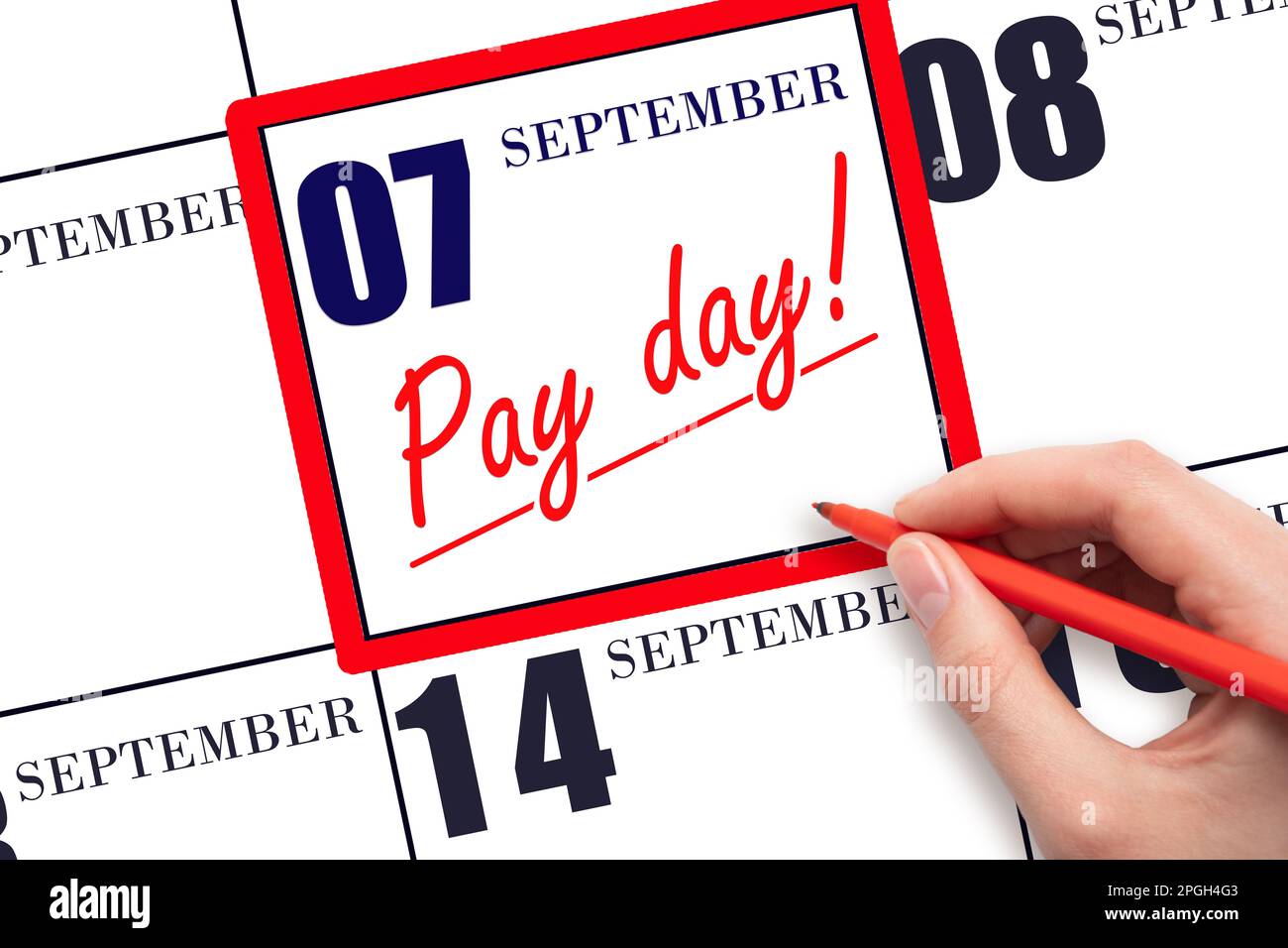 7th day of September. Hand writing text PAY DATE on calendar date September 7 and underline it. Payment due date. Reminder concept of payment. Autumn Stock Photo