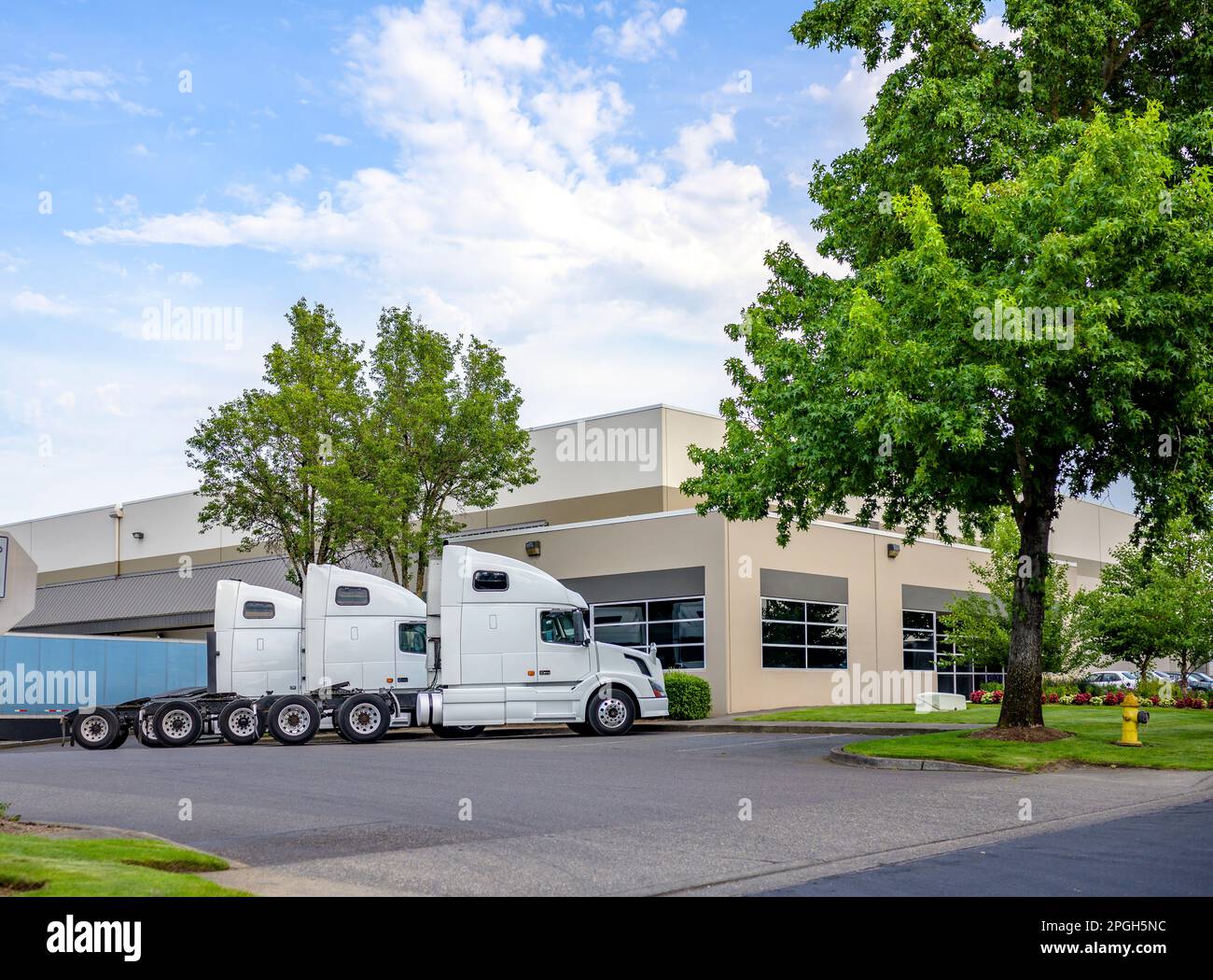 Industrial big rigs semi truck tractors with semi trailers standing ...