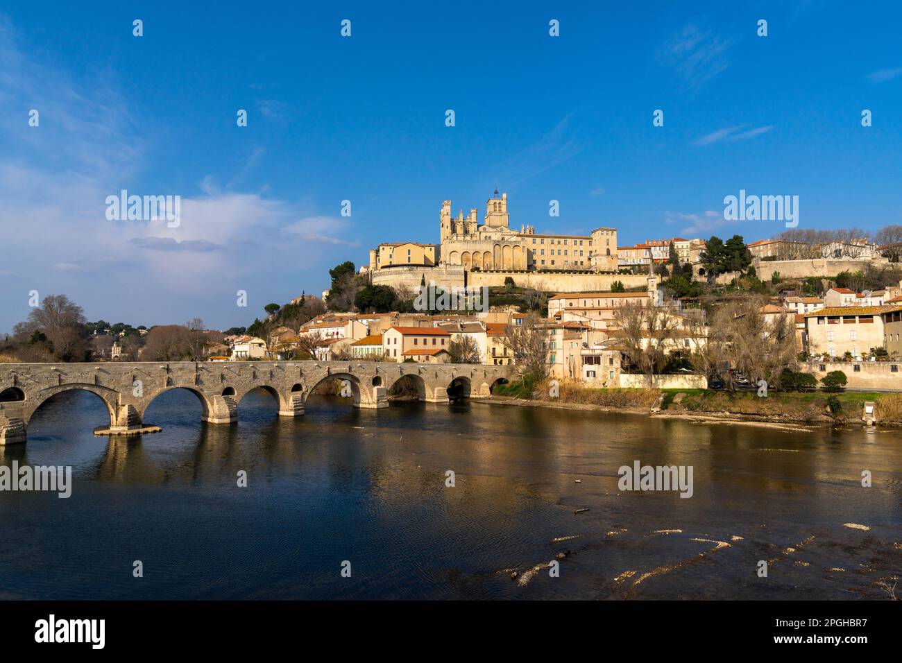 Beziers, France - 2 March, 2023: view of the historic old town center of Beziers with Saint Nazaire Church and roman bridge over the river Orb Stock Photo