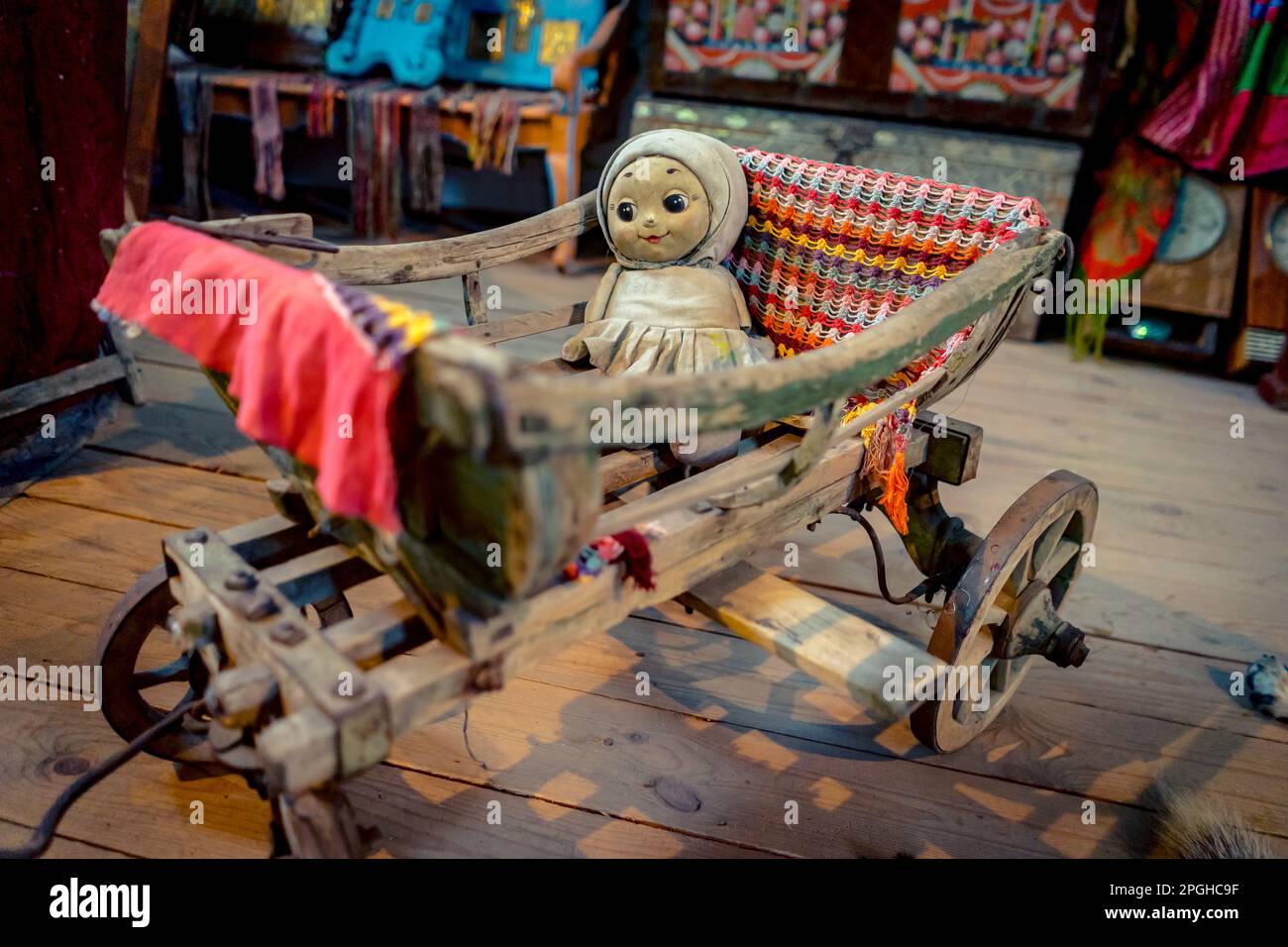 Creepy baby girl doll in a cradle on wheels Stock Photo