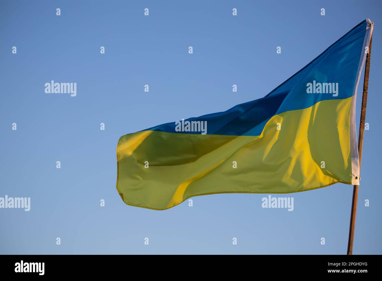 Detail of the national flag of Ukraine waving in the wind on a clear day. Democracy and politics. Stock Photo