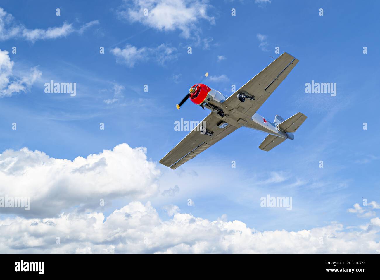 View of an aerobatic plane (aerodyne), in flight under a blue sky with white clouds. flight exhibitions Stock Photo