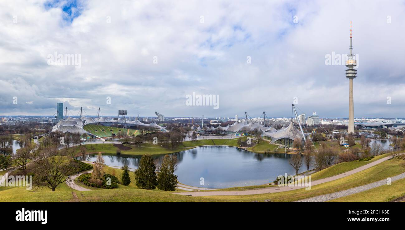 Olympiapark at Munich with Olympic Stadium, Olympiahalle, lake and Olympiaturm television tower Stock Photo