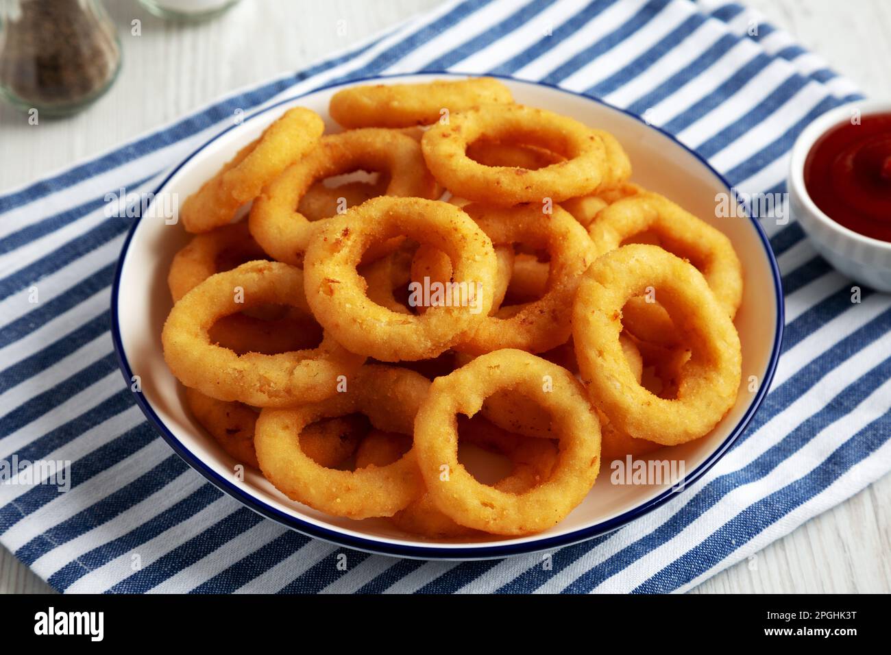 Homemade Breaded Onion Rings with Ketchup on a Plate, low angle view