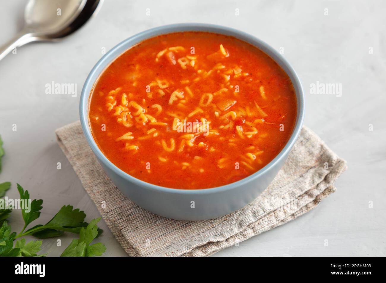 Homemade Alphabet Soup in Tomato Sauce in a Bowl, side view. Close-up