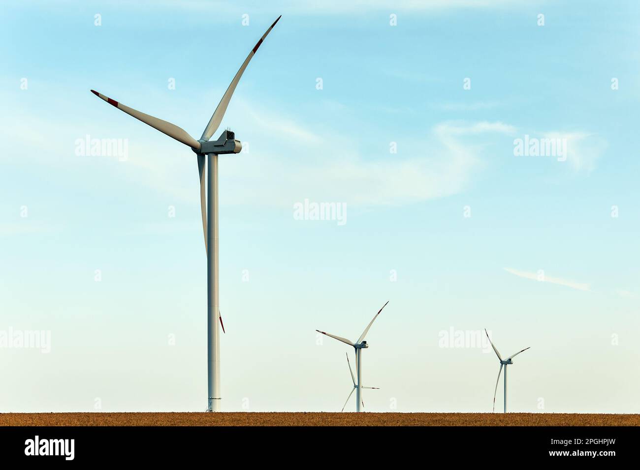 Wind turbines at sunset. Alternative energy concept. Several wind