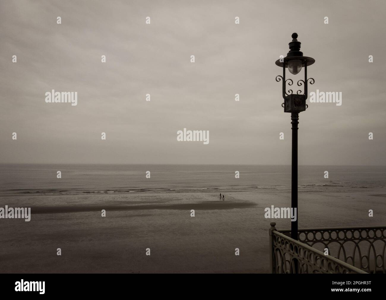 Image of Scarborough beach with a metal detectorist in the distance