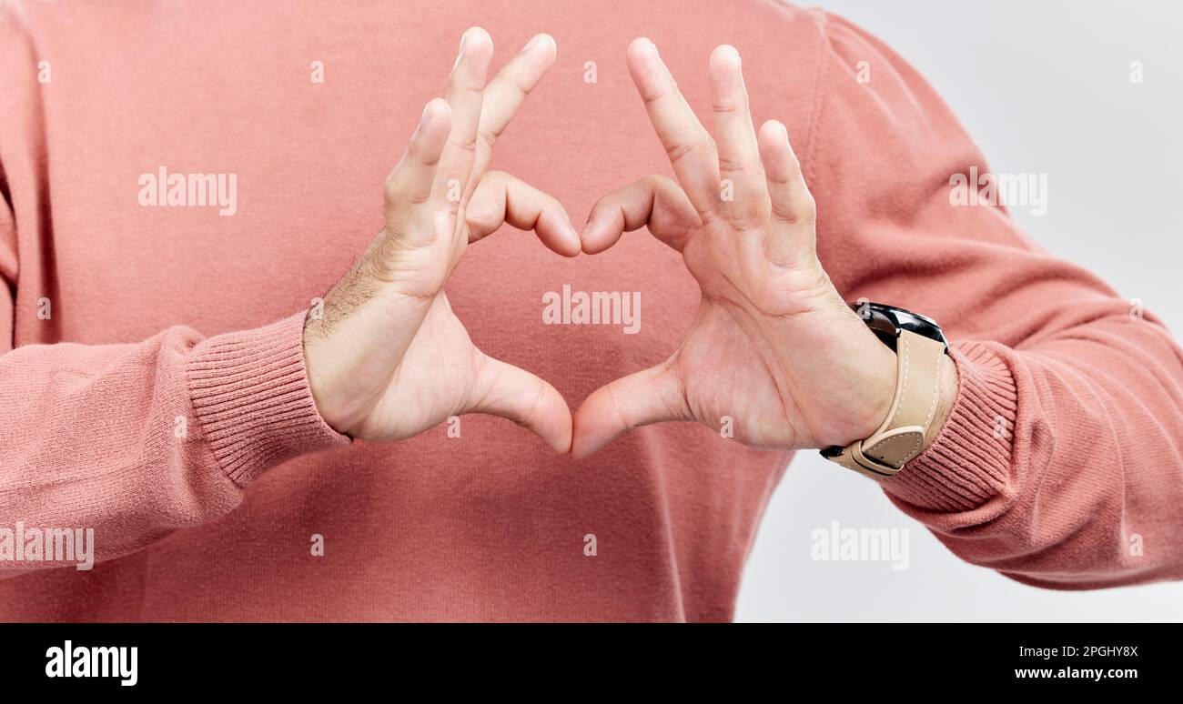 Hands, heart and man with love in studio to show support, thank you or ...